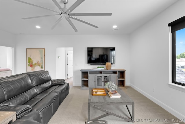 living room featuring baseboards, light carpet, a ceiling fan, and recessed lighting