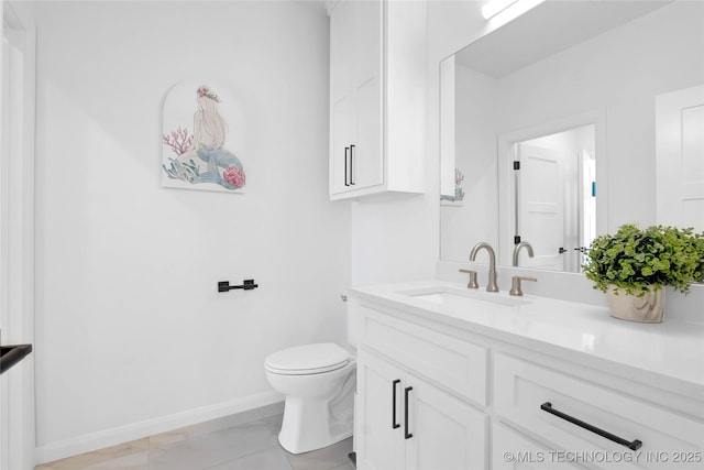bathroom with baseboards, vanity, toilet, and marble finish floor