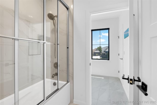 bathroom featuring baseboards, bath / shower combo with glass door, and marble finish floor