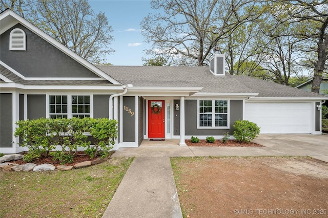 view of front of home featuring driveway, a chimney, an attached garage, a shingled roof, and stucco siding