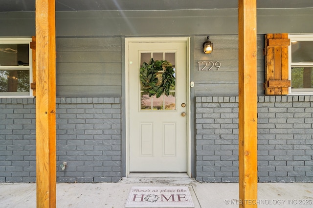 entrance to property with brick siding