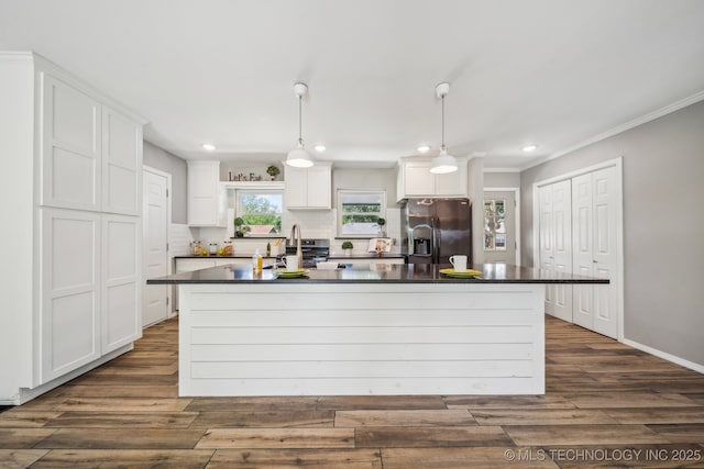 kitchen featuring white cabinets, dark countertops, and stainless steel fridge with ice dispenser