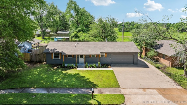 single story home featuring fence, roof with shingles, a front lawn, a garage, and concrete driveway