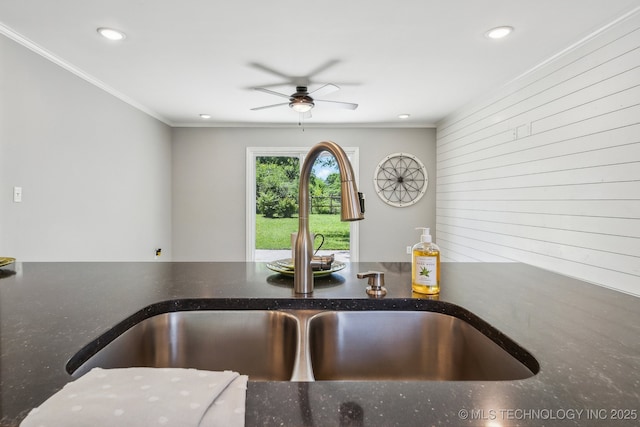 interior details with a ceiling fan, recessed lighting, a sink, and dark stone countertops
