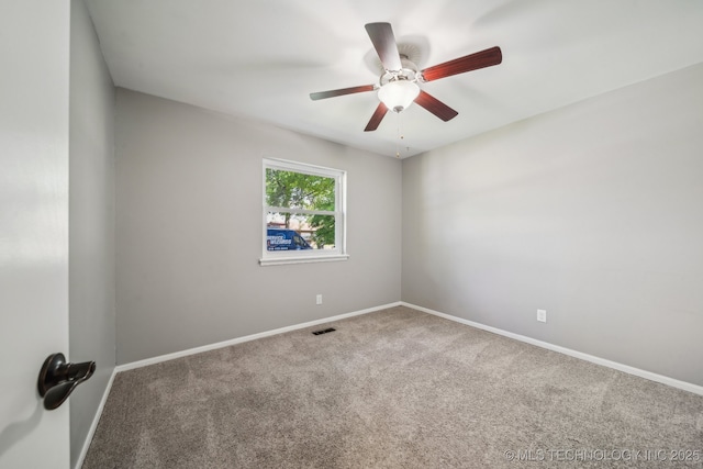carpeted empty room with visible vents, a ceiling fan, and baseboards