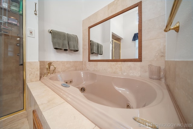 bathroom featuring a jetted tub and a stall shower