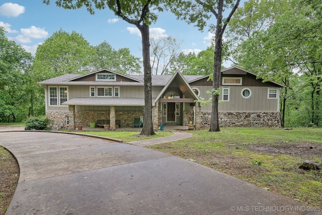 149 SE 4404th Loop, Locust Grove, OK 74352 - view of front of home with stone siding, asphalt driveway, roof with shingles, and a front lawn