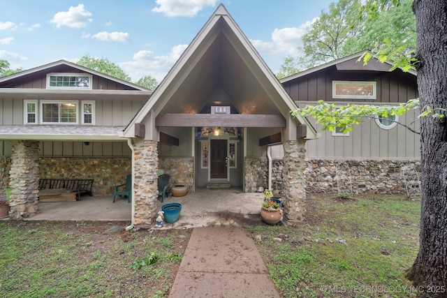 view of front facade with board and batten siding and stone siding