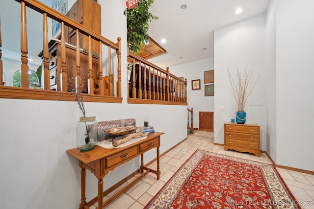 hallway featuring recessed lighting and stairway