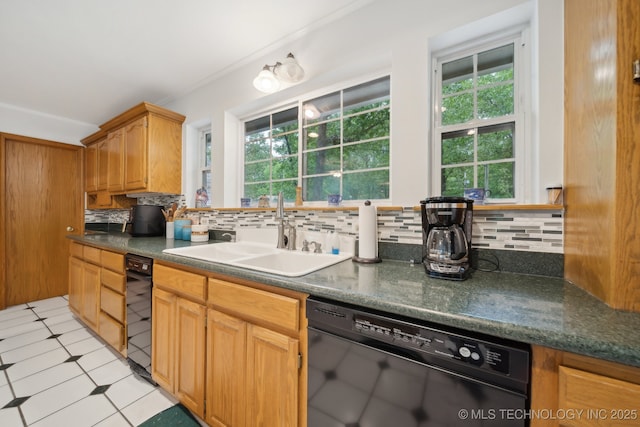 kitchen featuring crown molding, dark countertops, black dishwasher, a sink, and backsplash