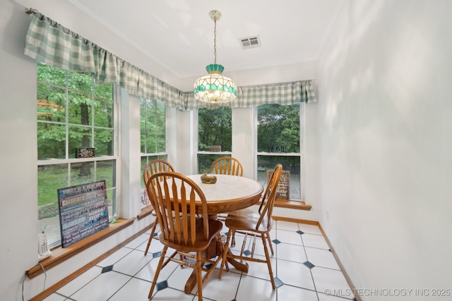 dining area with crown molding, baseboards, and visible vents