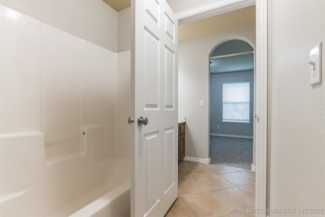 full bath with baseboards and tile patterned floors