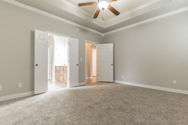 unfurnished bedroom with baseboards, ornamental molding, a raised ceiling, and light carpet
