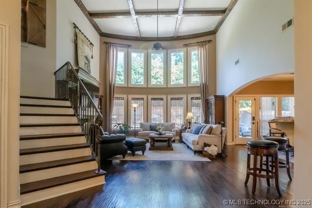 11615 S New Haven Ave, Tulsa, OK 74137 - living room with arched walkways, wood finished floors, a towering ceiling, visible vents, and coffered ceiling