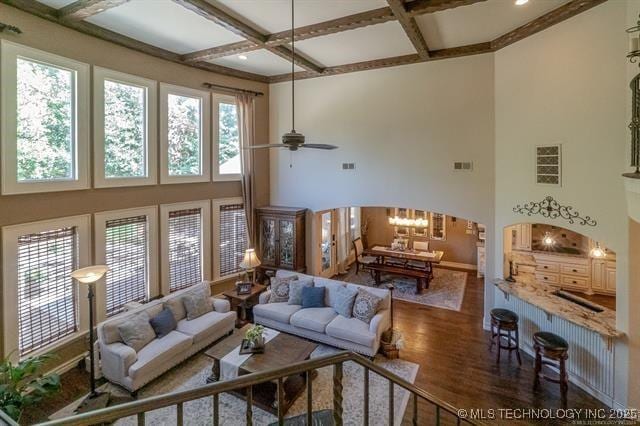 11615 S New Haven Ave, Tulsa, OK 74137 - living area with visible vents, coffered ceiling, a towering ceiling, and wood finished floors