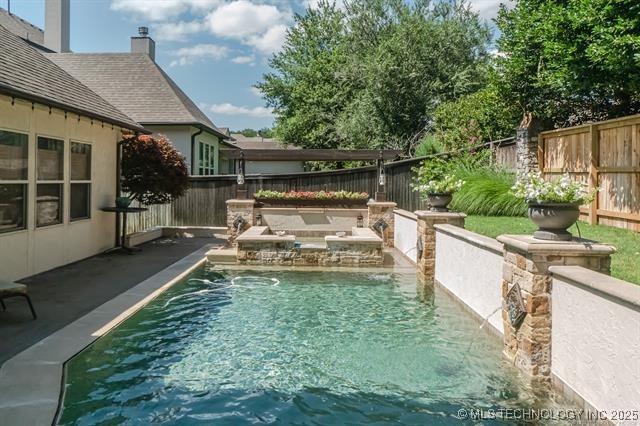 11615 S New Haven Ave, Tulsa, OK 74137 - view of swimming pool with a fenced in pool, a fenced backyard, and a patio