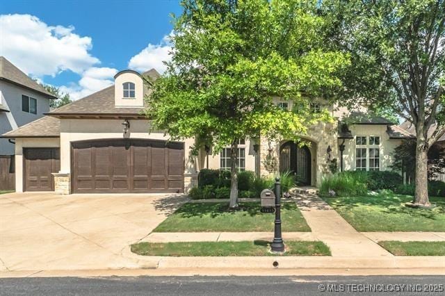 11615 S New Haven Ave, Tulsa, OK 74137 - view of front of property featuring an attached garage, driveway, stucco siding, and stone siding
