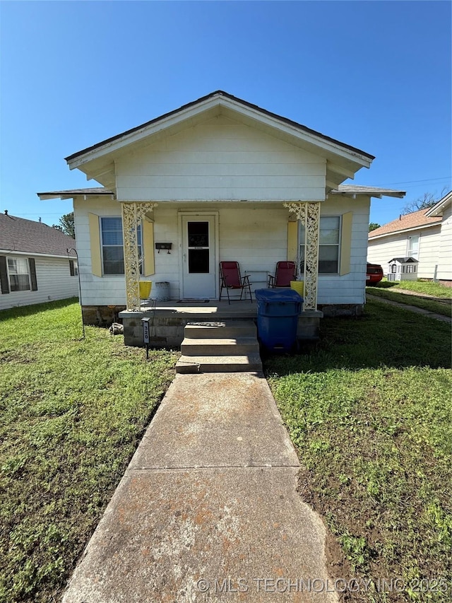 bungalow-style house featuring a porch and a front lawn