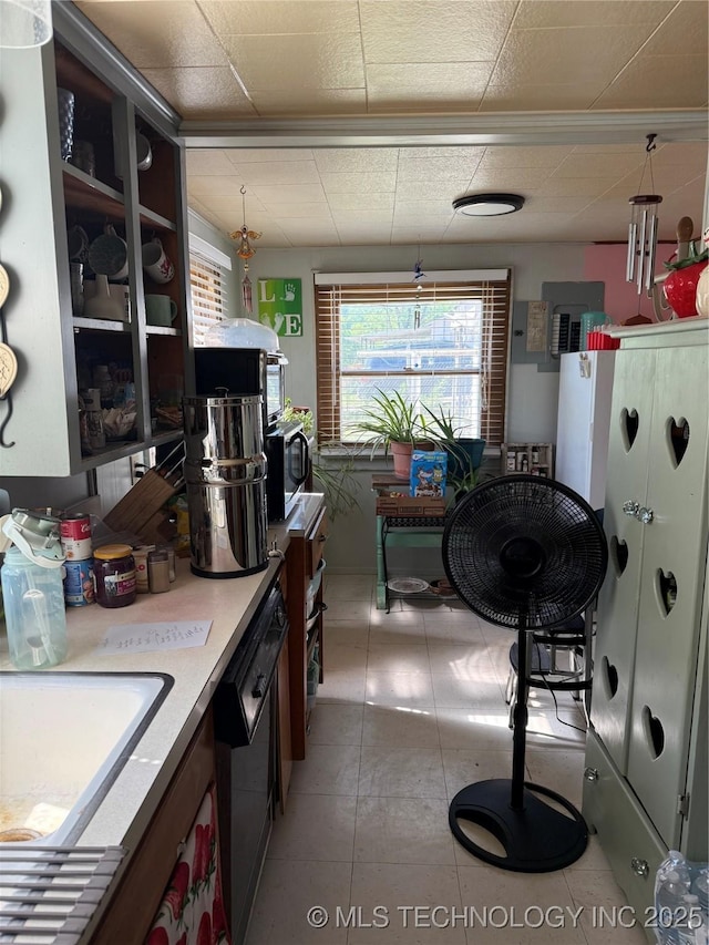 kitchen featuring stainless steel microwave, a sink, a paneled ceiling, and dishwashing machine