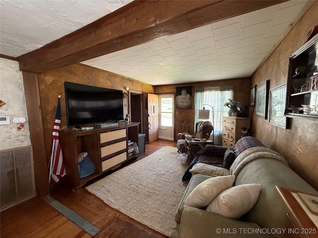 living area featuring visible vents and wood finished floors