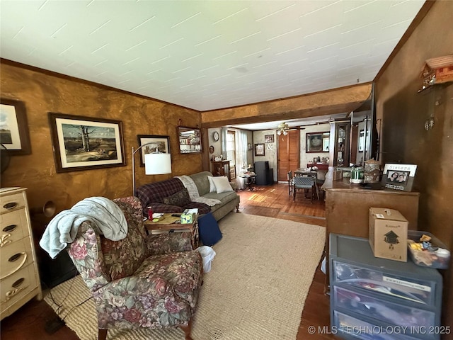 living area with crown molding and wood finished floors