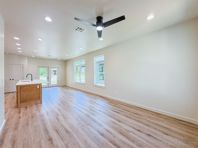 unfurnished living room with recessed lighting, baseboards, visible vents, and light wood-style flooring