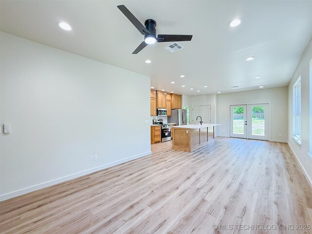 unfurnished living room with a ceiling fan, baseboards, recessed lighting, light wood-type flooring, and visible vents