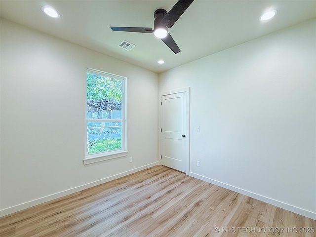 spare room featuring ceiling fan, visible vents, wood finished floors, baseboards, and recessed lighting