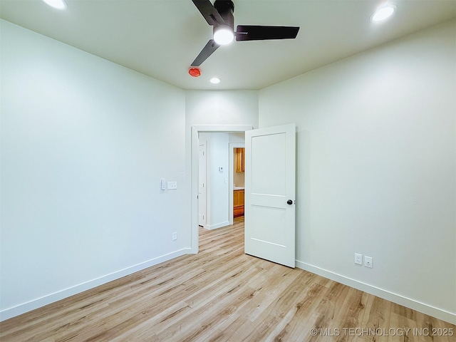 spare room featuring light wood-style floors, baseboards, a ceiling fan, and recessed lighting