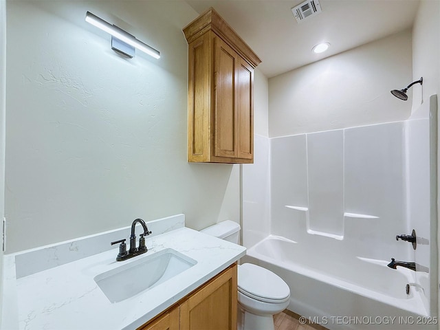 bathroom with shower / bathtub combination, toilet, visible vents, and vanity