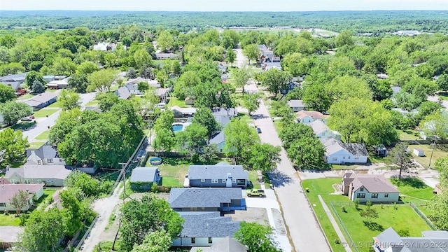 birds eye view of property with a view of trees and a residential view