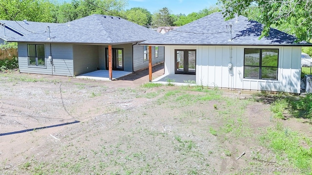 back of house featuring board and batten siding, a patio, french doors, and roof with shingles