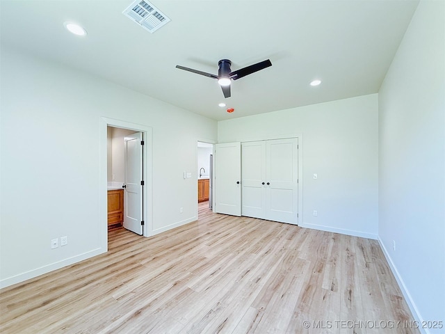 unfurnished bedroom with visible vents, baseboards, a closet, light wood-style floors, and recessed lighting