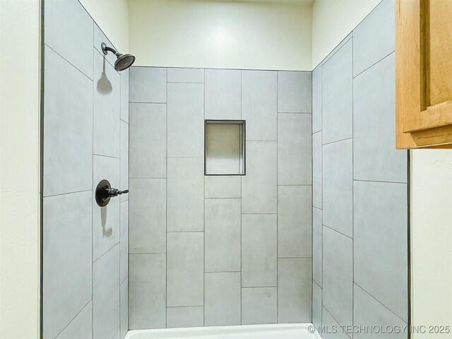 full bath featuring tiled shower