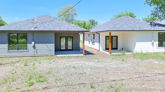 back of house featuring french doors, a patio, and a shingled roof