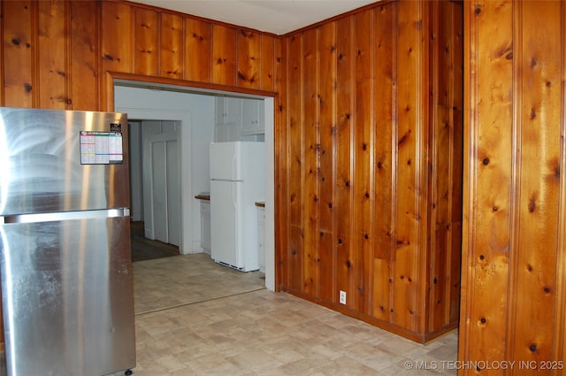 hall with wood walls and light floors