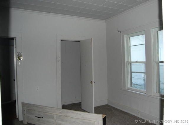unfurnished bedroom featuring baseboards and ornamental molding