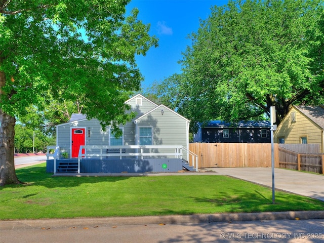 view of front of property with a front lawn and fence