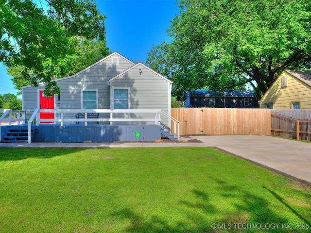exterior space featuring fence and a front lawn