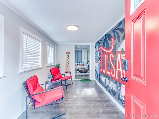 sitting room featuring baseboards and wood finished floors