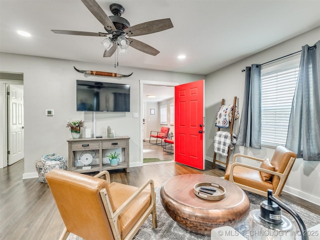 living room featuring a ceiling fan, baseboards, recessed lighting, and wood finished floors
