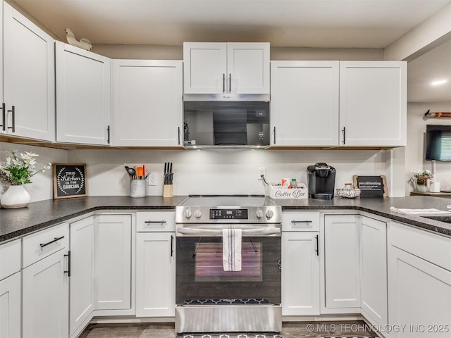 kitchen featuring white cabinets and electric stove