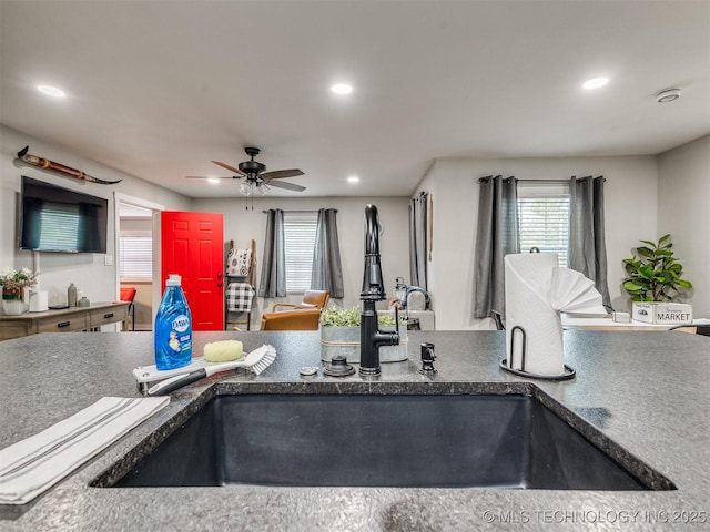 kitchen featuring a sink, dark countertops, a ceiling fan, and recessed lighting