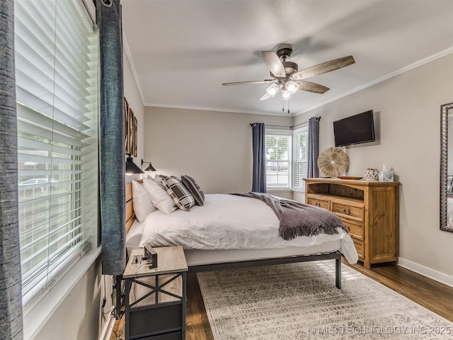 bedroom featuring crown molding, baseboards, ceiling fan, and dark wood-type flooring