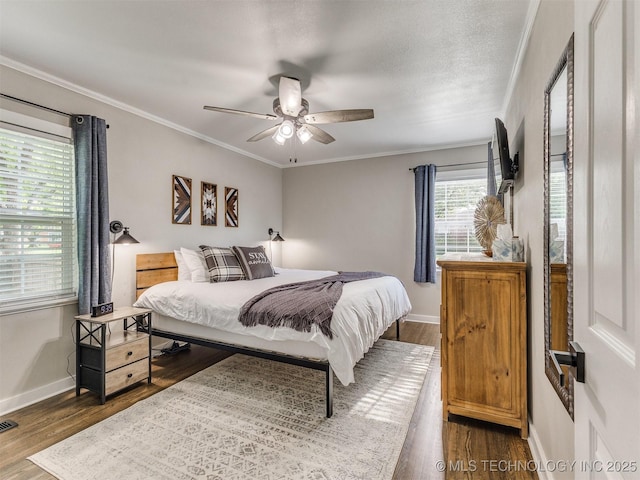 bedroom featuring baseboards, ornamental molding, and dark wood-style floors