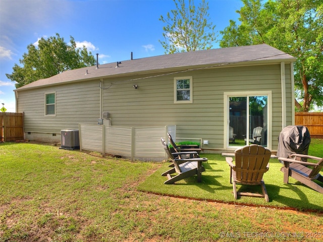 back of property featuring a yard, crawl space, fence, and cooling unit