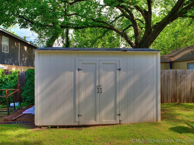 view of shed with fence