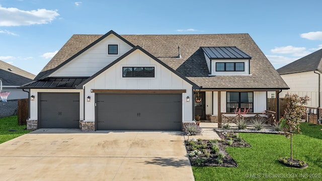 view of front of home featuring roof with shingles, a front lawn, a porch, concrete driveway, and a standing seam roof