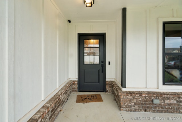 view of exterior entry with board and batten siding