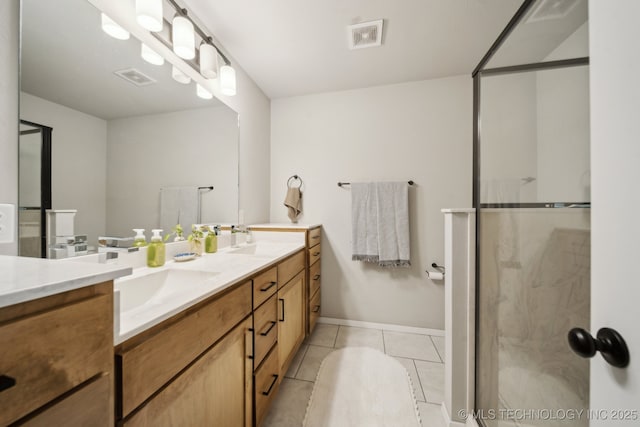 full bath featuring double vanity, tile patterned flooring, a shower stall, and a sink